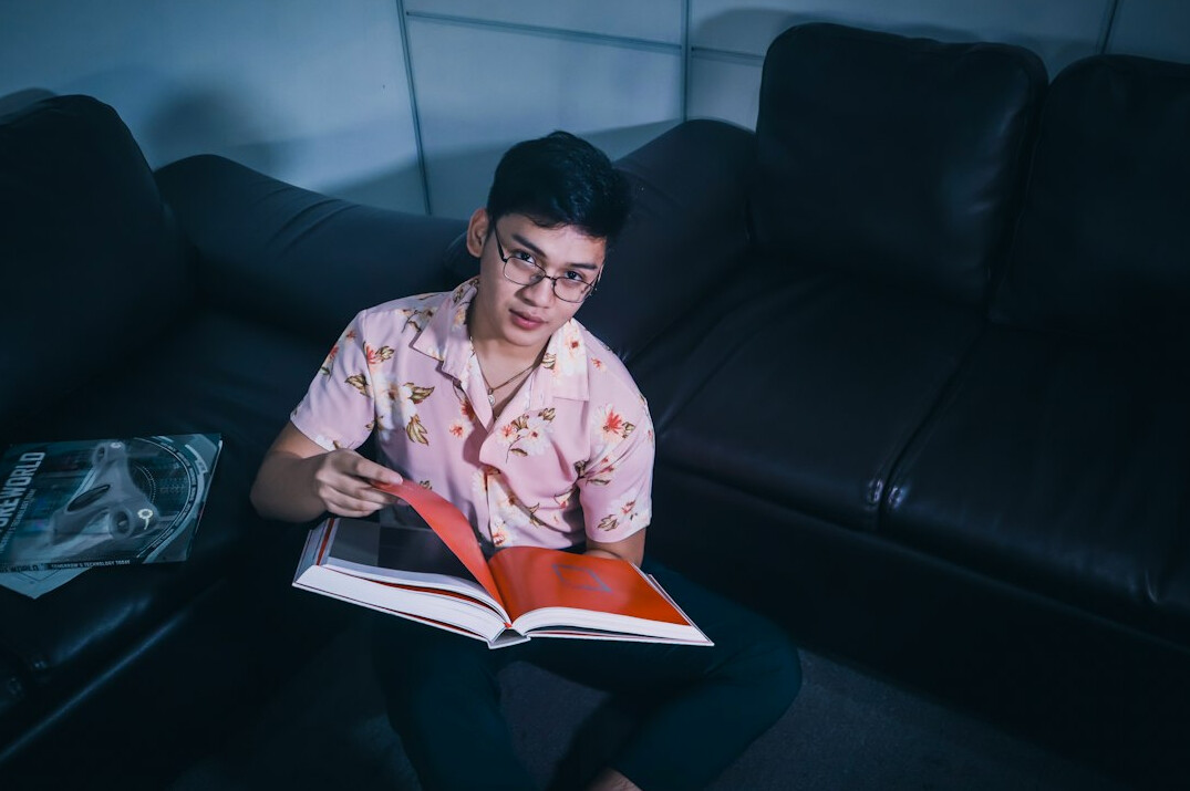 person reading thriller at night